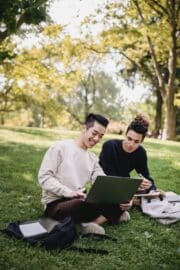 Happy people outside with laptop computer