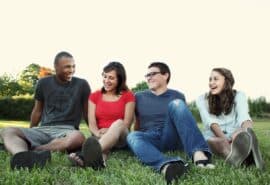 Happy people sitting in the grass
