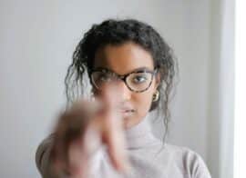 Serious woman pointing at the camera